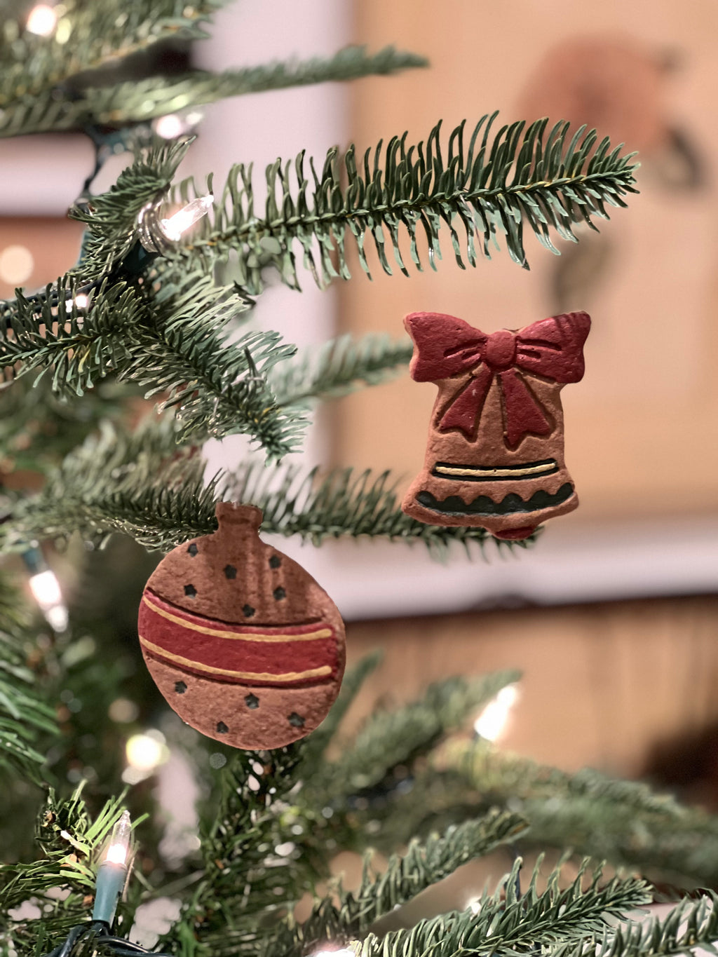 Wooden Christmas ornaments on a tree with blurred background