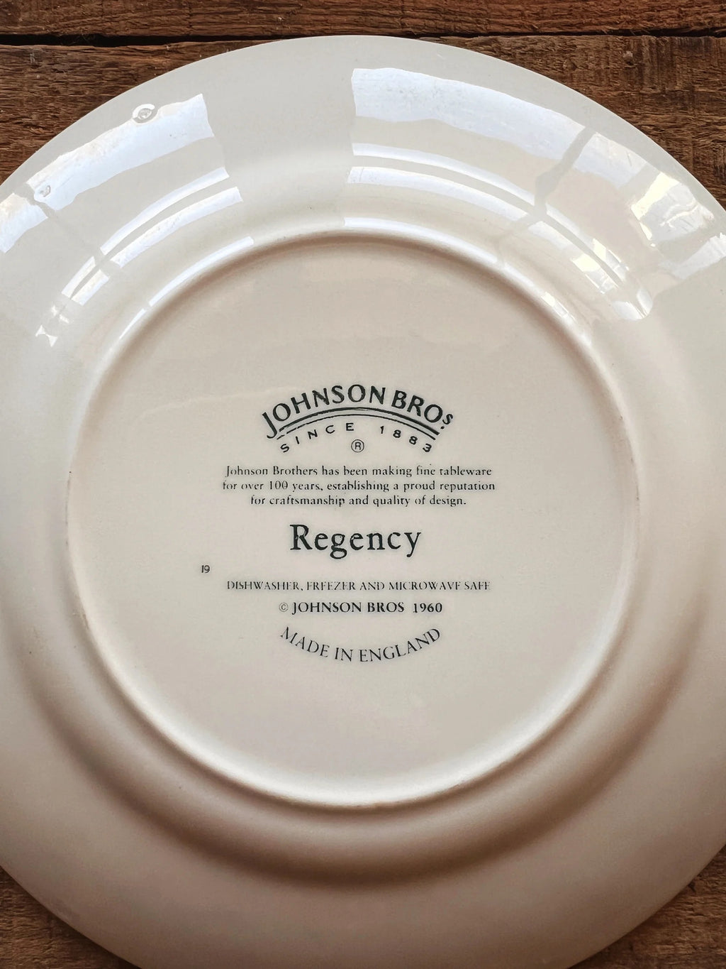 Close up of green Johnson Brothers England maker’s mark on vintage Regency bread plate