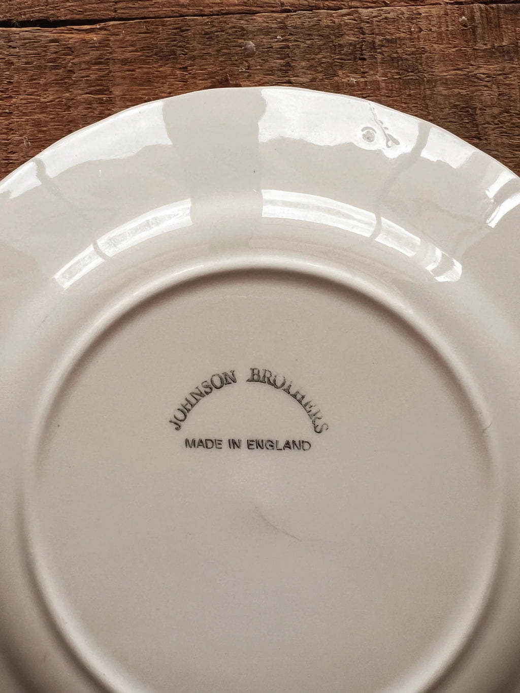 Close up of black Johnson Brothers England maker’s mark on vintage Regency bread plate