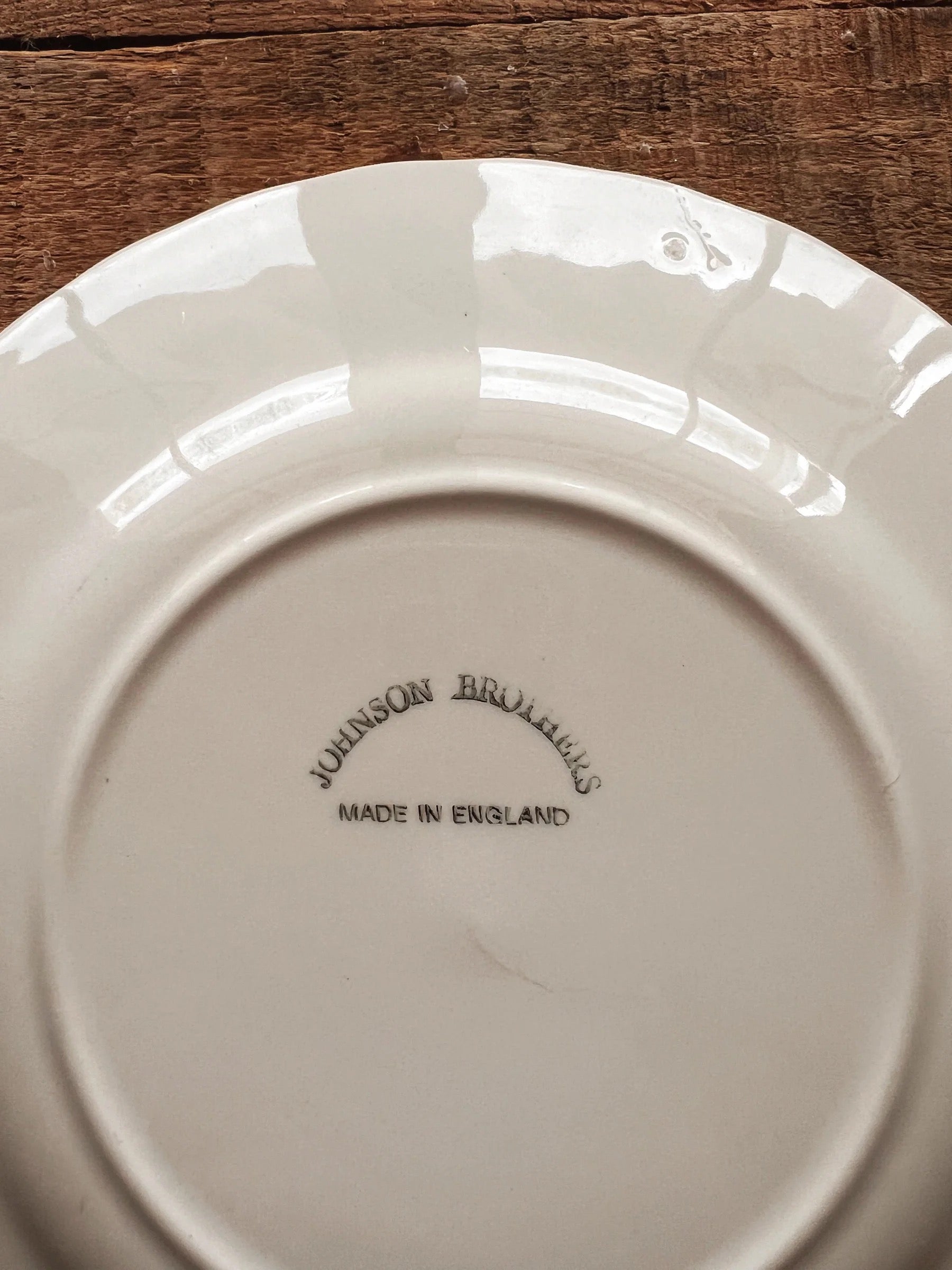 Close up of black Johnson Brothers England maker’s mark on vintage Regency bread plate