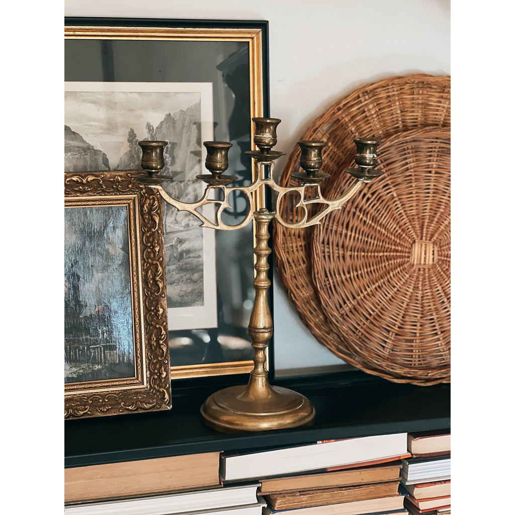 brass 5 arm candelabra on a shelf