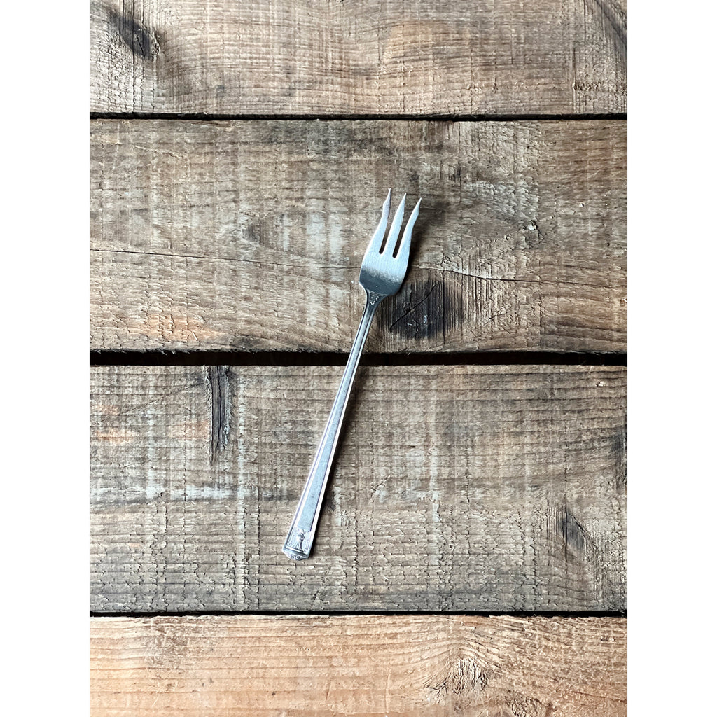 Silver fork on a wooden surface