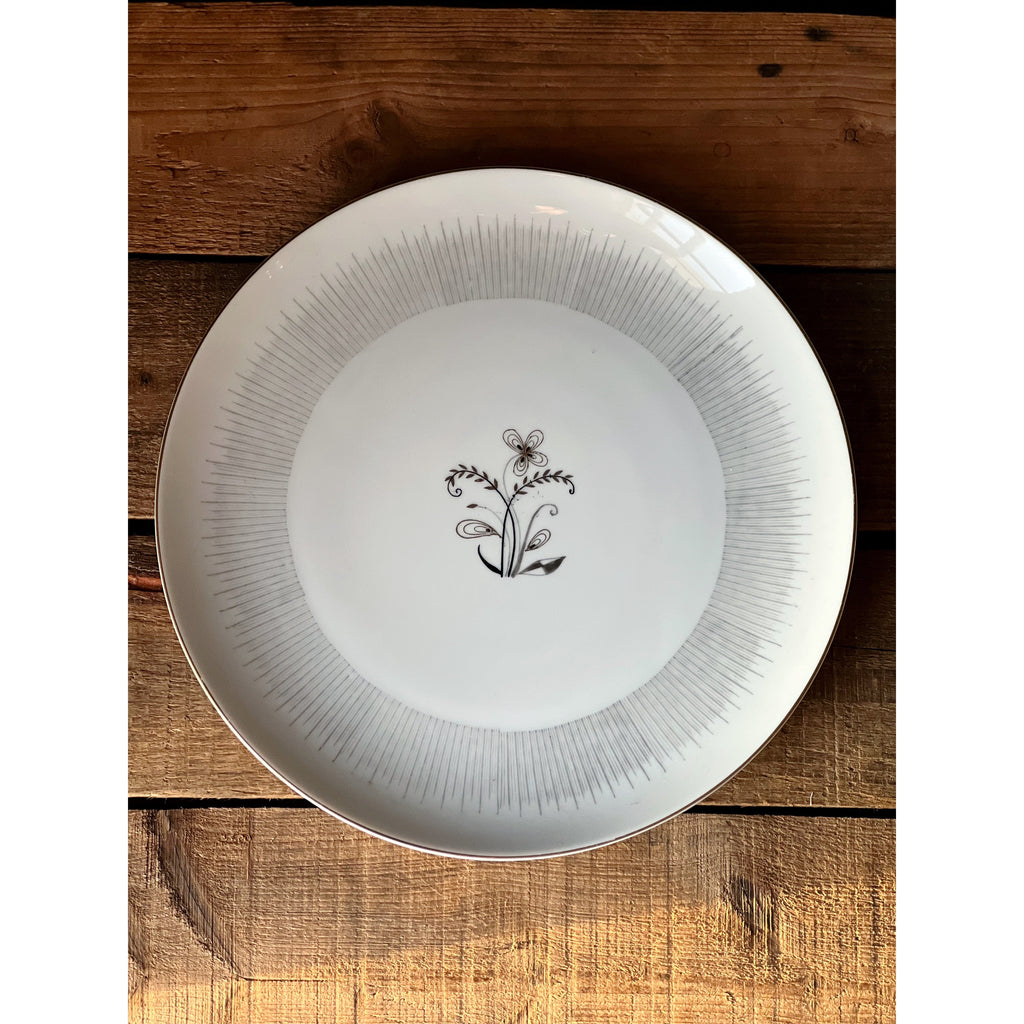 Vintage Togo Japan Floral Dinner Plate  with decorative black design on a wooden surface