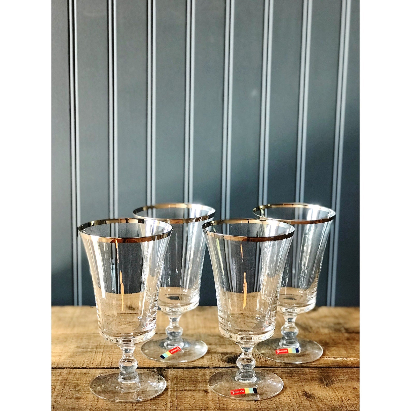 silver rim glasses on a wood surface
