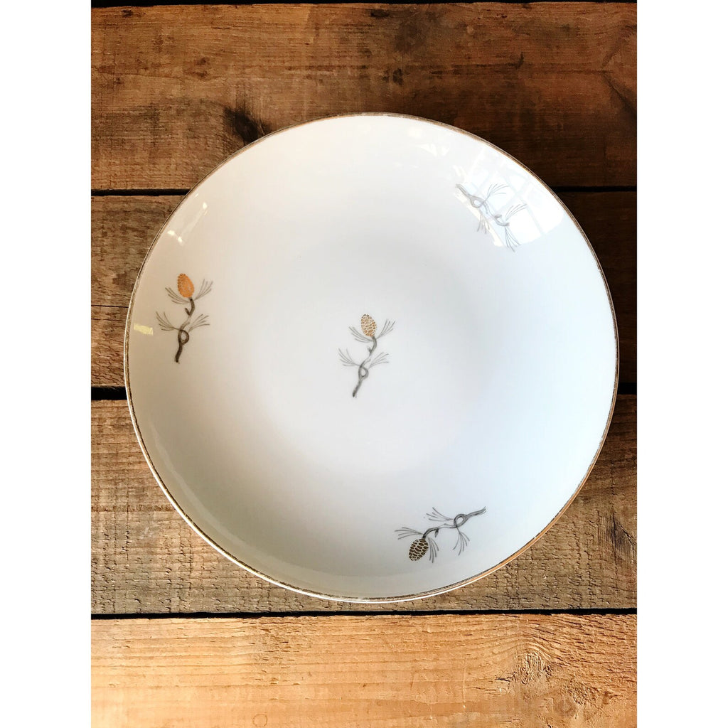 gray gold and white soup bowl on a wooden table
