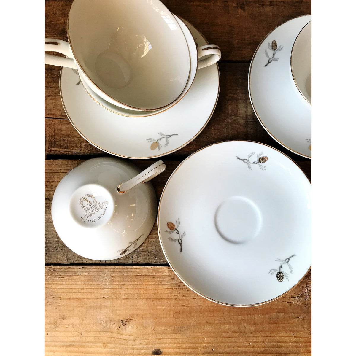Vintage Sone China Japan Pinecone Teacup & Saucer Sets on a wooden table